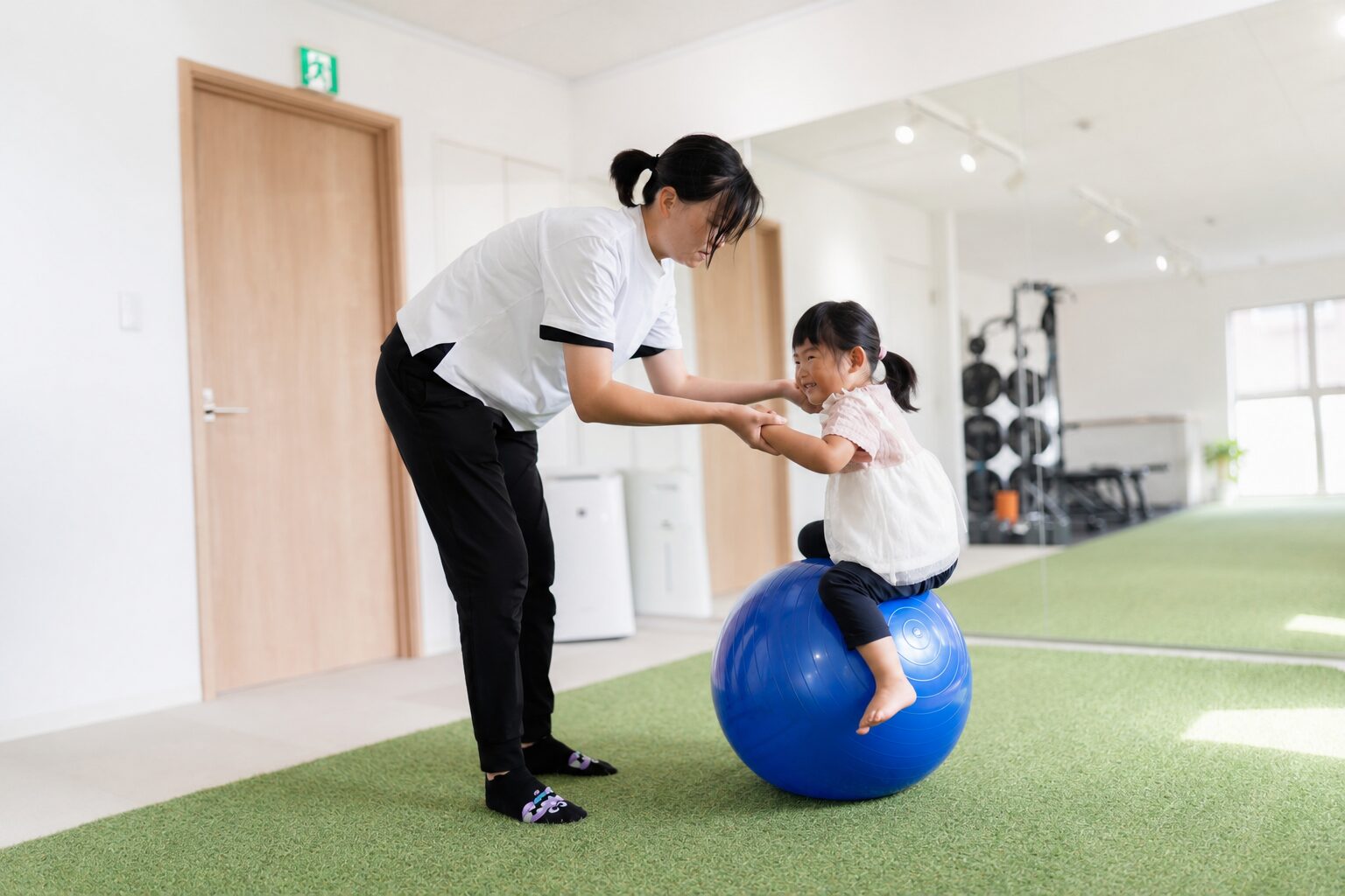 子連れでパーソナルトレーニングを受ける母娘・バランスボールで遊ぶ子ども｜東海市太田川TRAD